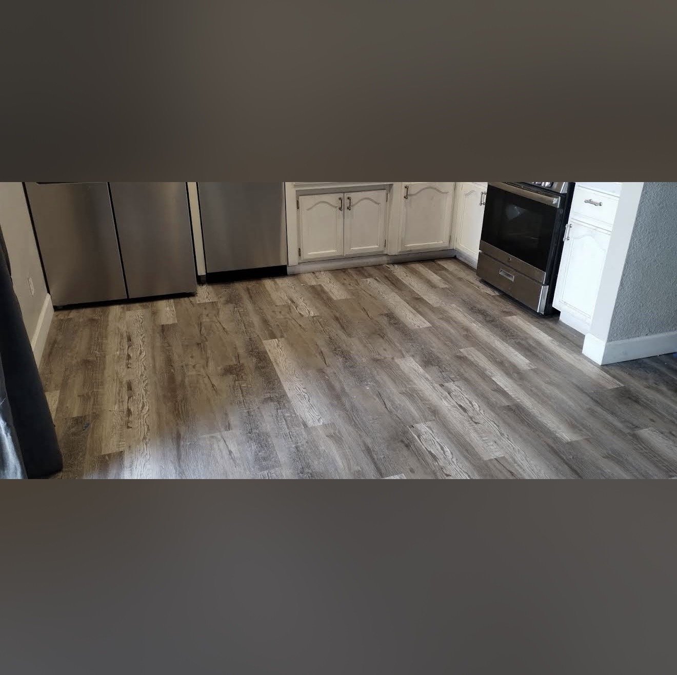 Kitchen with luxury vinyl plank flooring in grey wood-look finish — Stockton kitchen remodel by Cazares